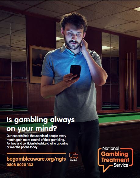 Man looking at his phone, seeming unsure as to whether or not he should reach out for help. Text states "Is gambling always on your Mind? Our experts help thousands of people every month gain more control of their gambling. For free and confidential advice chat to us online or over the phone today."